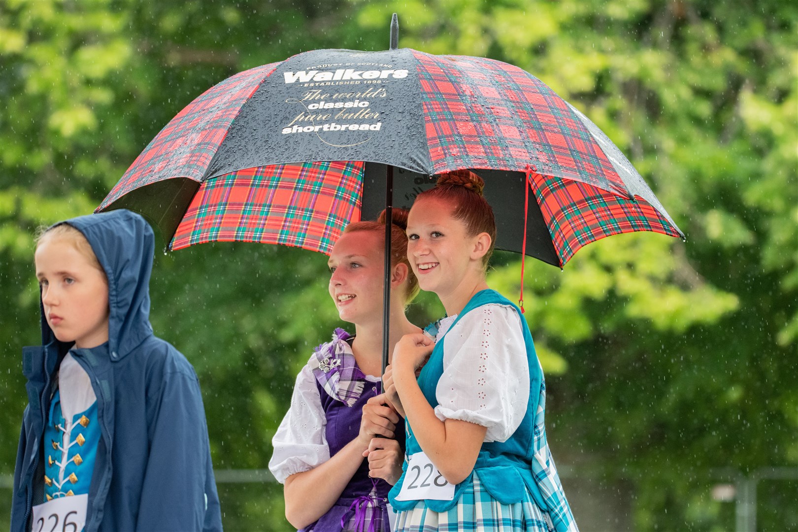 Sheltering from the rain before they take to the Highland Dancing stage. ..The 78th Aberlour Strathspey Highland Games, held at Alice Littler Memorial Park...Picture: Daniel Forsyth..