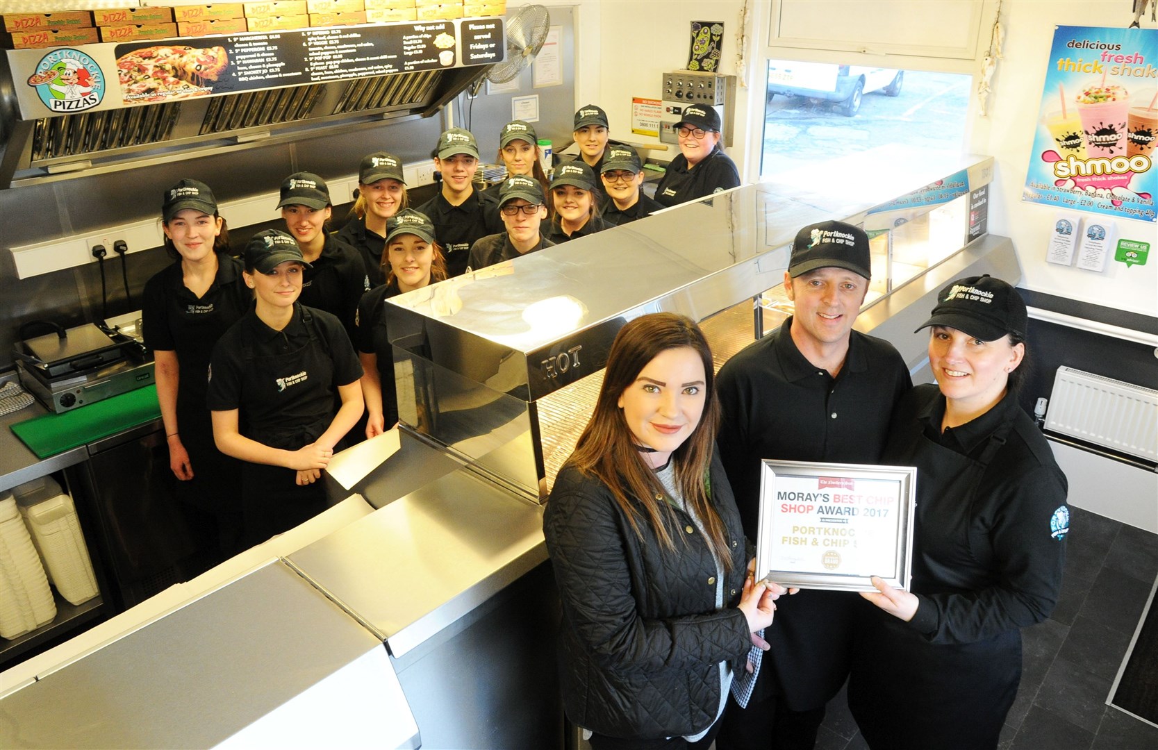 Portknockie Fish and Chip Shop owners Moira Proctor and Ian Nuttall receive their Moray Best Fish and Chip Shop Award from Northern Scot sales representative Claire Miller. Picture: Eric Cormack.