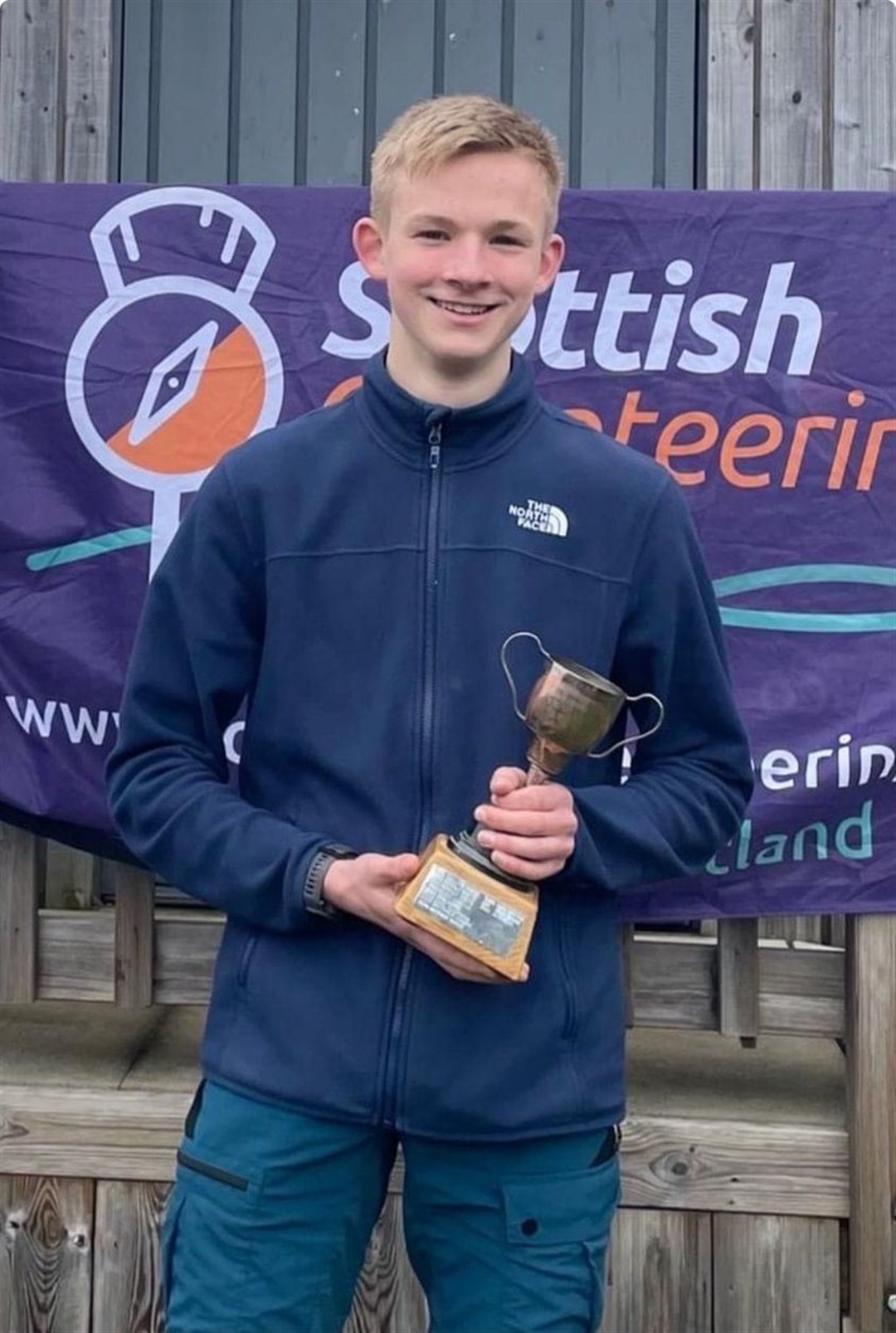 Finlay McLuckie with his trophy for last year's Scottish Orienteering League.