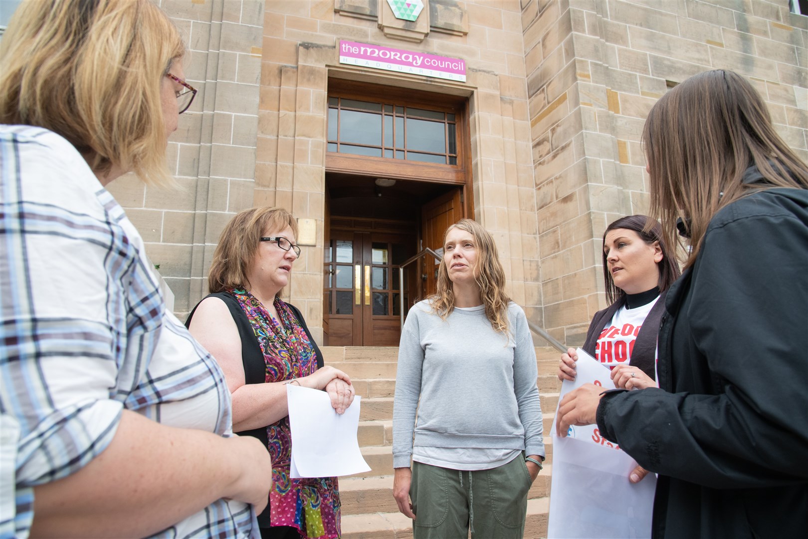Cllr Sonya Warren speaks to some of the protesters. ..Demonstrators gather outside Moray Council's Headquarters ahead of a full council meeting to protest the proposed cuts to school staff. ..Picture: Daniel Forsyth..