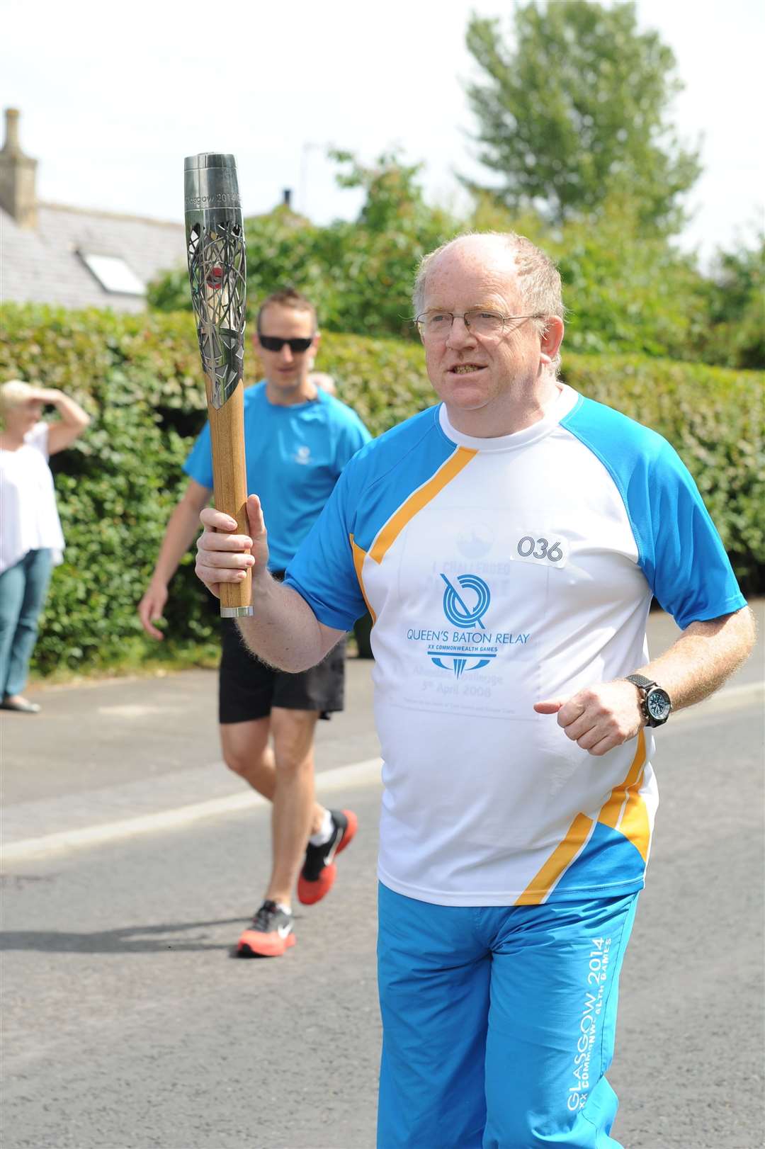 Ken carries the Queen's baton through Mosstodloch in 2014 before the Commonwealth Games. Picture: Eric Cormack