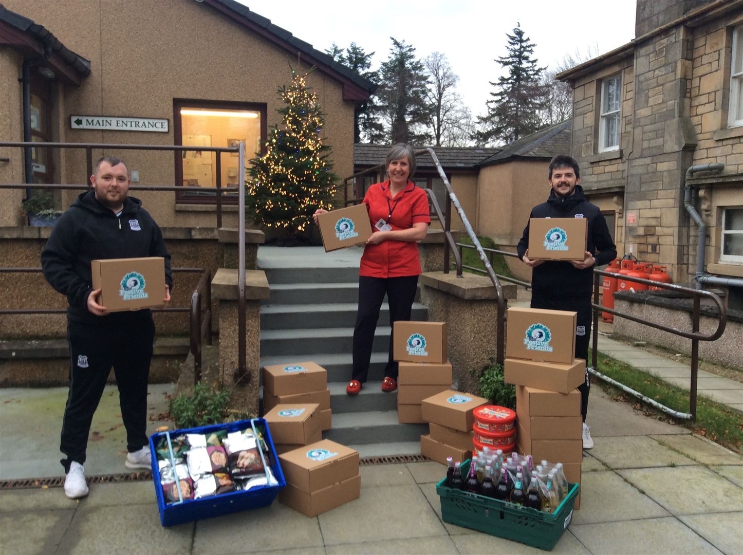 Elgin City drop hampers at The Grove. Left to right: Craigh Stewart, Alison Gauld Robertson & Keiran Carty.