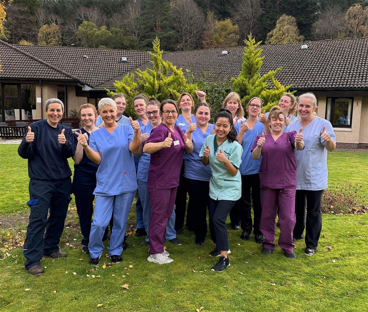 Speyside Care Home's staff members celebrate receiving a five-star rating. Manager Louise Gillies is front and centre, in purple.