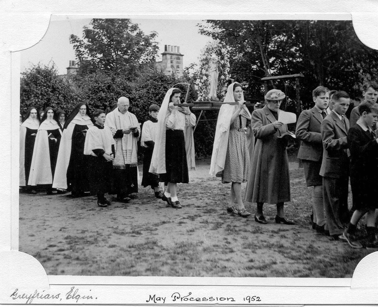 The Sisters of Mercy having a Marian procession in the convent garden in 1952.