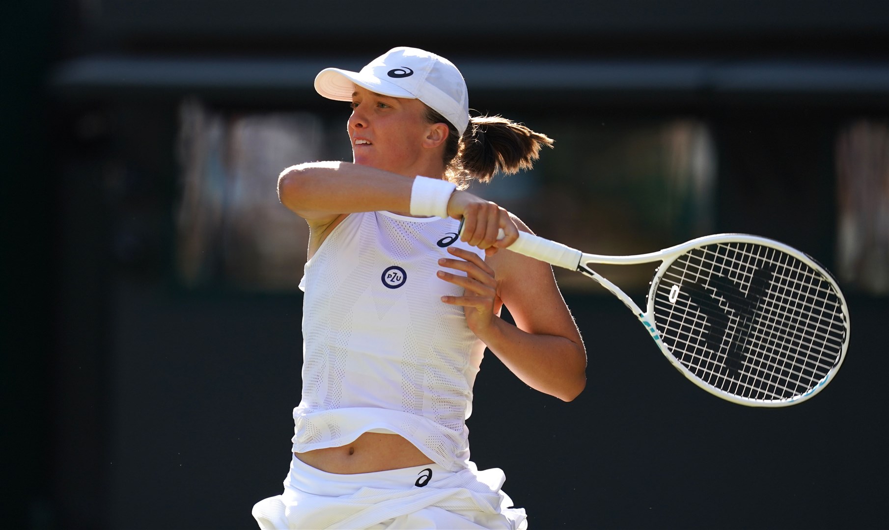 Iga Swiatek in action during her second round match against Lesley Pattinama Kerkhove during day four of the 2022 Wimbledon Championships (John Walton/PA)
