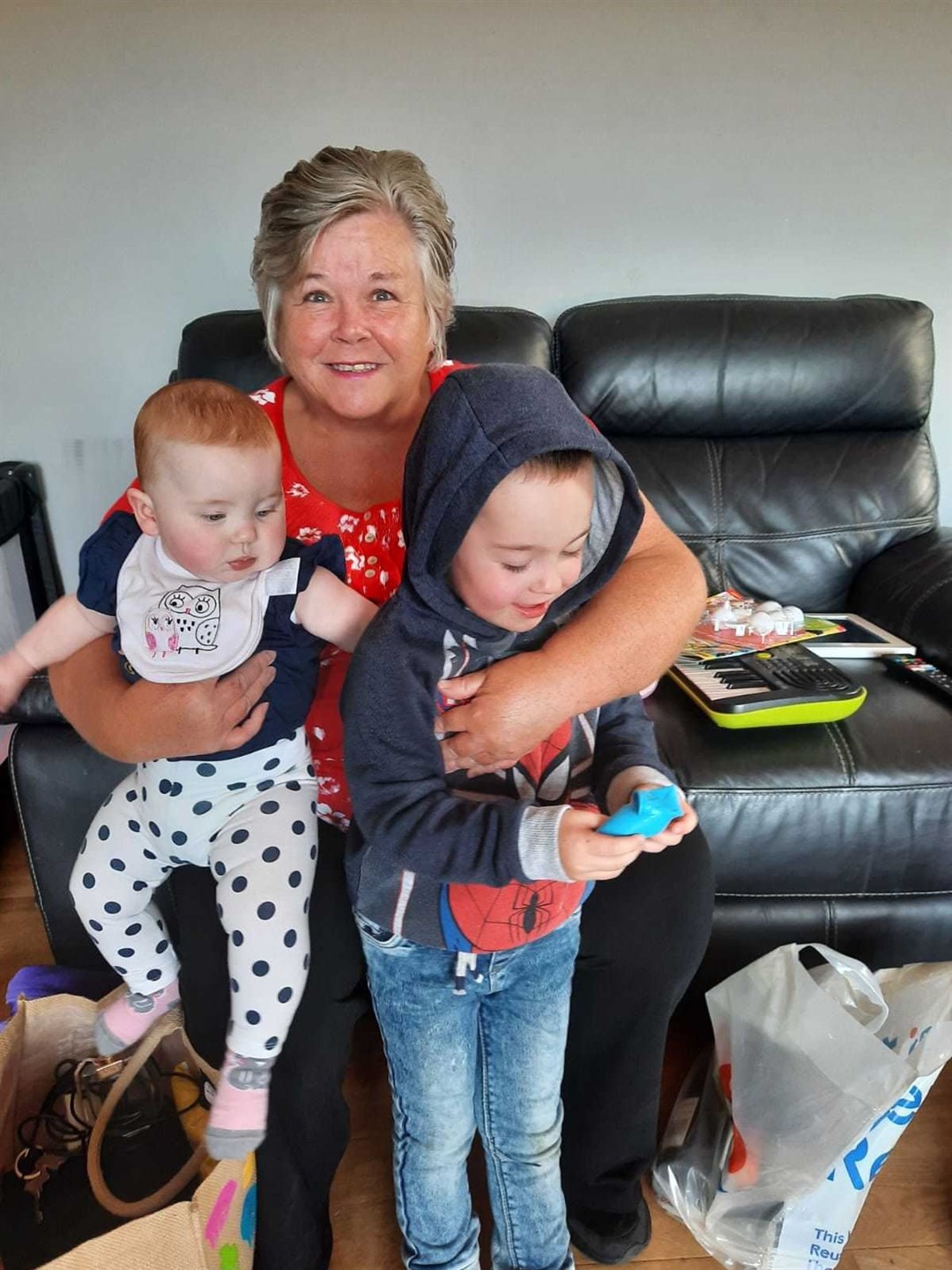 Kate Walker (Granny Buckie) gathers up grandchildren Danny (3) and six-month-old Chloe, from Lossiemouth, for cuddles.