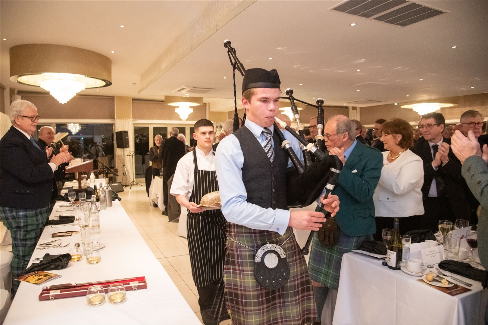 The haggis, carried by Marcus Milton, is piped in by Gordonstoun Piper Hamish Martindale. ..Elgin Burns Club's annual anniversary dinner at the Mansefield Hotel. ..Picture: Daniel Forsyth..