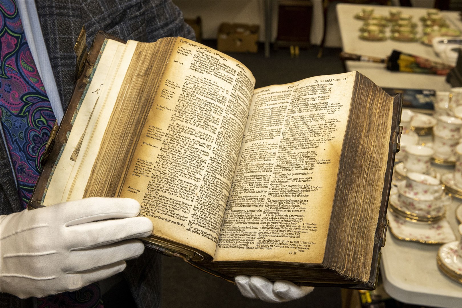 Bloomfield Auctions’ managing director Karl Bennett holding a Breeches Bible, Geneva Edition printed by Robert Parker, which dates back to 1615 (PA)