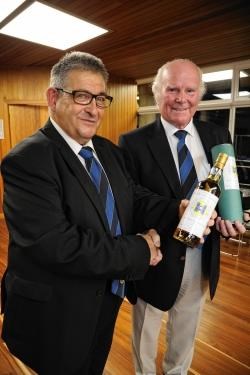 Mike Christie (right) is presented with a bottle of whisky by Elgin Boys' Club vice-president Graeme 'Tiger' Porter.