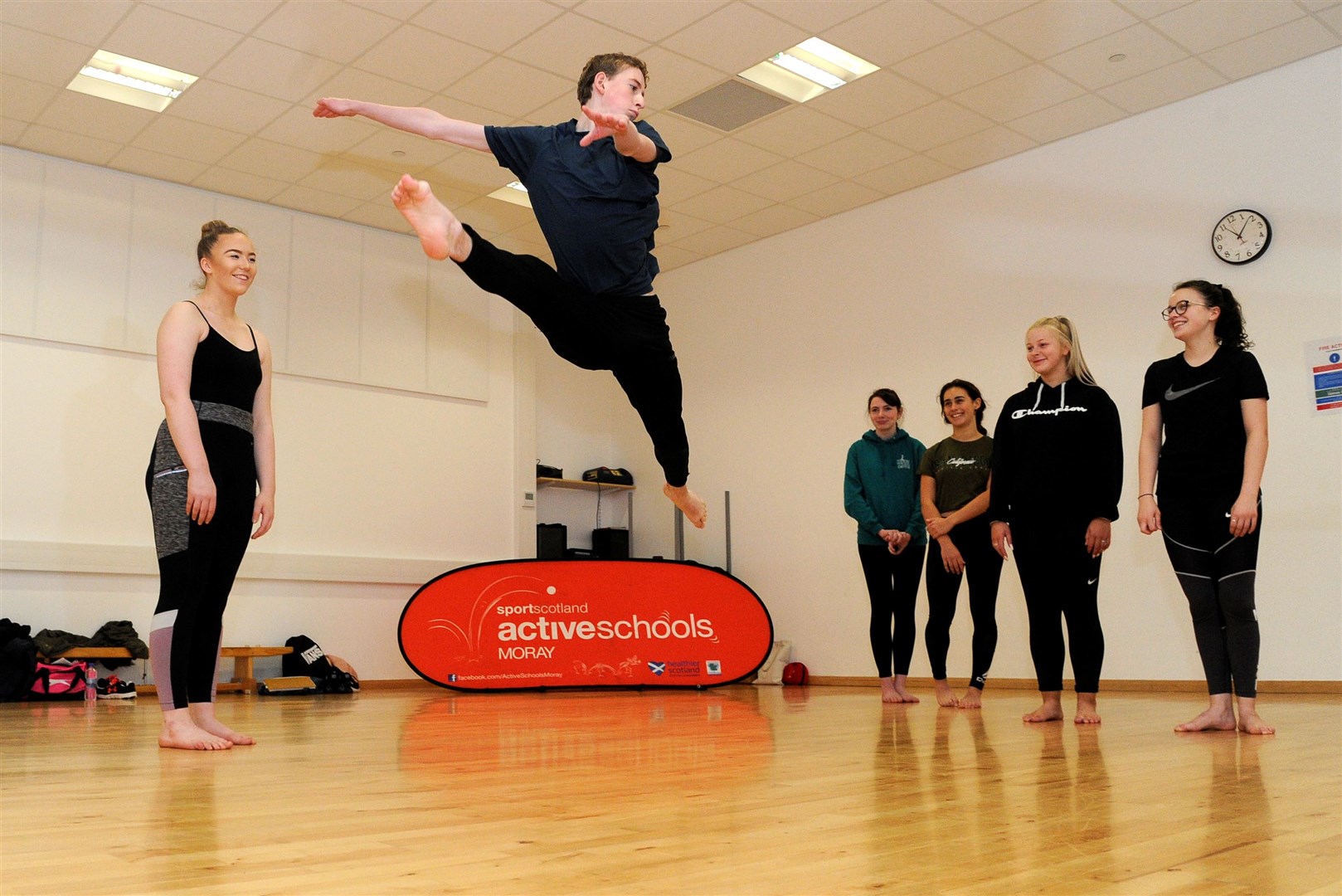 Moray Active Schools holding a dance leaders course at Elgin Academy dance studio. Josh Parkinson leaps into action, tutored by Caitlin Leslie (left) with pupils Sonya Willox, Mia Fraser, Mani McKee and Gemma Gerrie. Picture: Eric Cormack