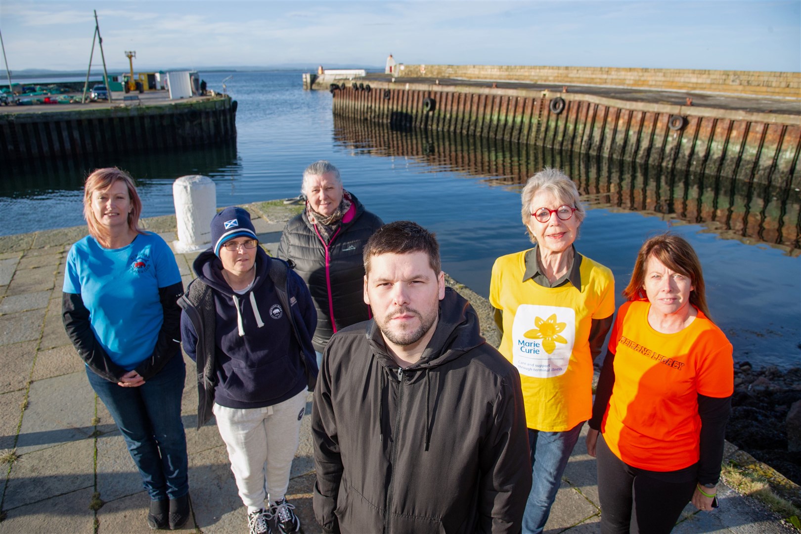 Jamie Campbell, the Burghead Boxing Day Swim's president, is joined by, from left, committee members Isabel Taylor and Sharyn Phillips, Burghead Sub Aqua Club secretary Nicola Gibson, Ros Lewis of Marie Curie and Sandra MckAndie, chairwoman of Keiran's Legacy – and mother of Keiran. Picture: Daniel Forsyth