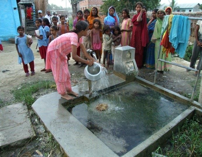 A local woman at the tasting from a fountain funded by the Rotary club in Laxmipur, Nepal in 2007