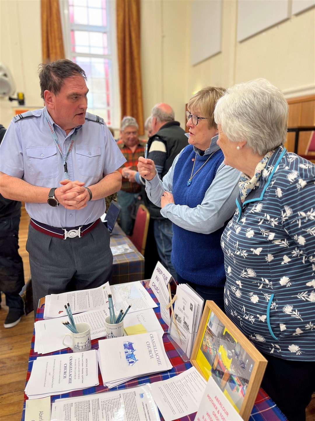 Jane Tweedie (middle) and Shiela Willox (right) of the Aberlour Parish Church hear about the from the The 423 (Speyside) Detached Flight Squadron, Air Training Corps.