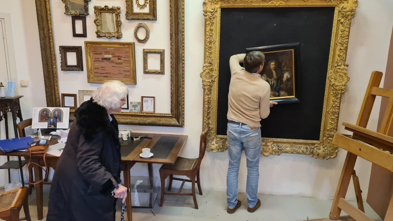 Mrs Charlotte Bischoff van Heemskerck visits a framer where she sees the painting for the first time in 80 years (Courtesy of the family of Charlotte Bischoff van Heemskerck/PA)