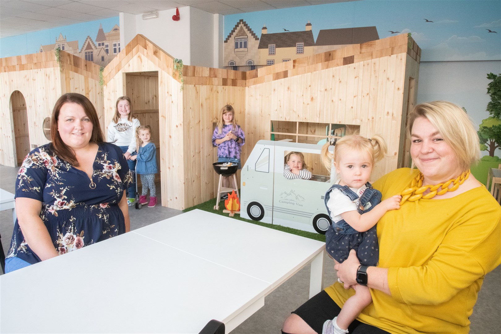 Child's play: Toy Toon will open in Elgin High Street this week by lifelong friends Jacqueline Main and Katy Larkworthy. Katy is holding her youngest daughter Livi (1). Poppy (7), her eldest daughter, is behind the BBQ, while Willow (3) is in the supermarket with Chloe Main (6). Jacqueline's other daughter, Emma (2), is in the camper van window. Picture: Daniel Forsyth