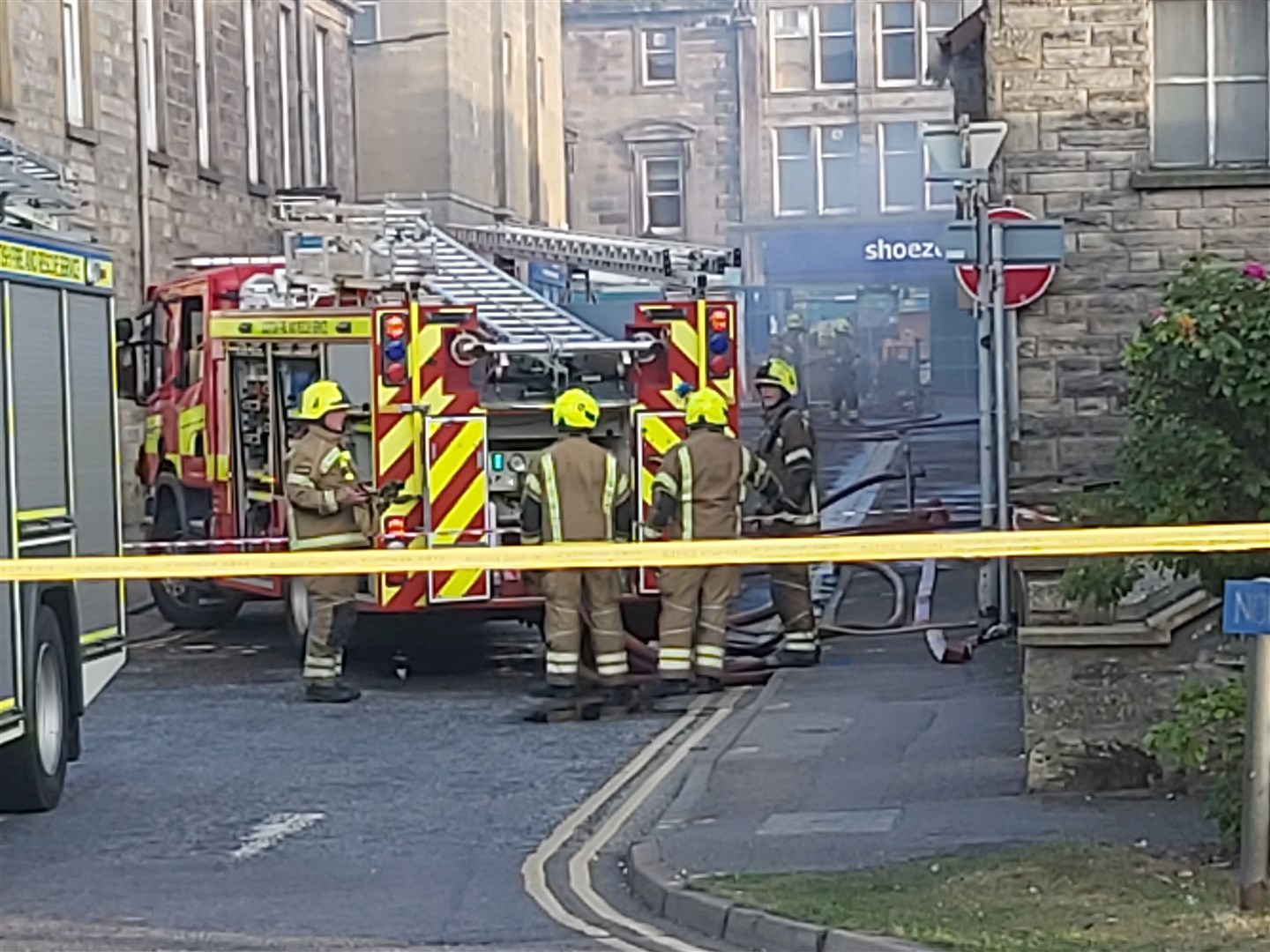 The scene last Friday as firefighters deal with the blaze and the public kept at a safe distance with a strict cordon. Picture: Highland News and Media