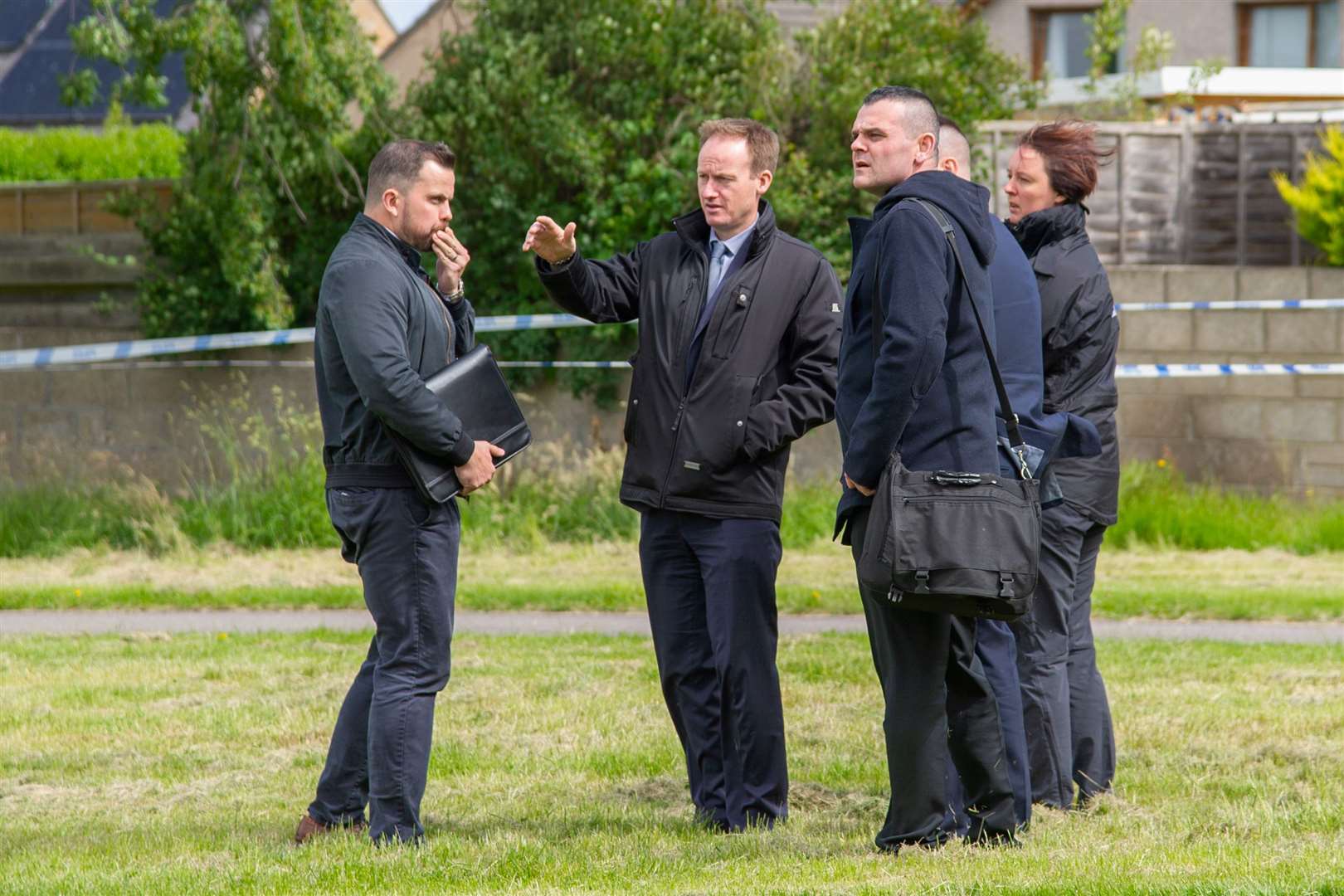 Officers discuss the investigation at Doocot Park. Picture: Daniel Forsyth.