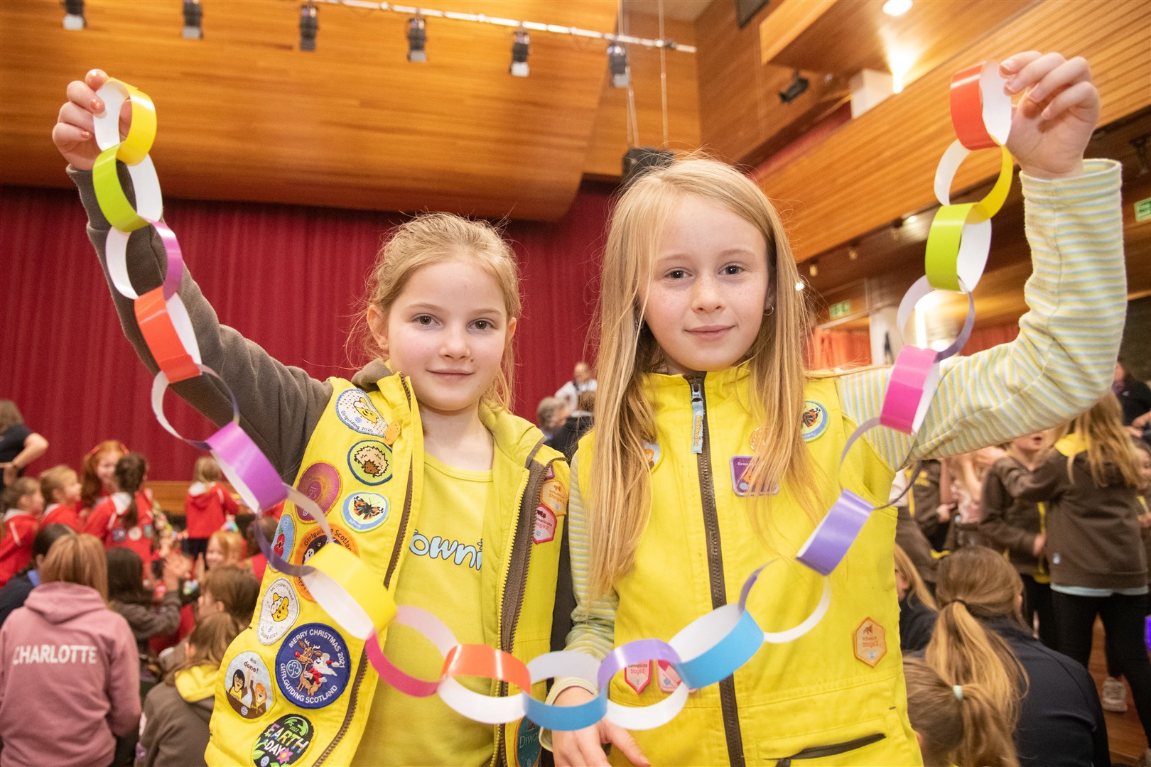 Making friendship link chains are Holly Benson (left) and Elsie Swadel (right) from the 1st Burghead Brownies group...Hundreds of Rainbows, Brownies and Guides gather in the Elgin Town Hall to celebrate World Thinking Day...Picture: Daniel Forsyth..