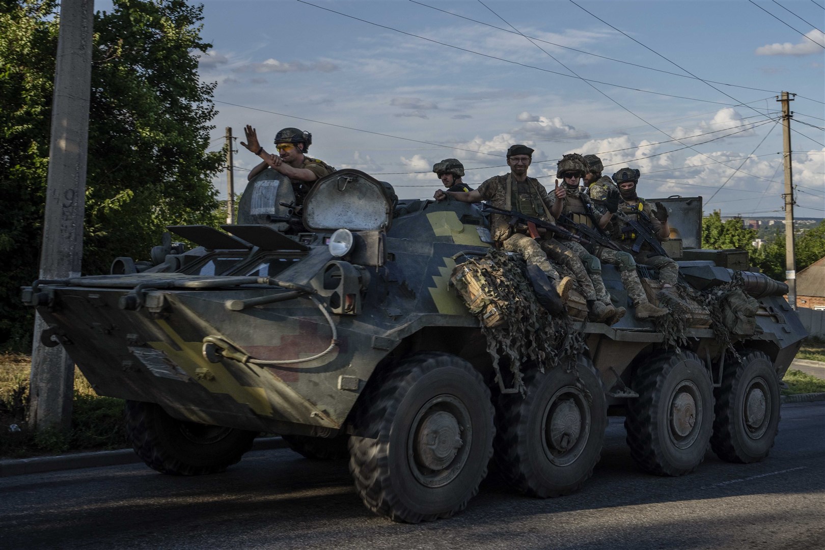 Ukrainian soldiers ride a tank, on a road in Donetsk region, eastern Ukraine (Nariman El-Mofty/AP)