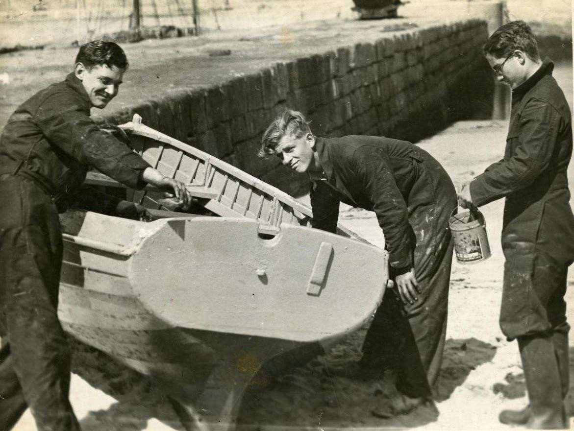 The prince (centre) learning boat maintenance in Hopeman.