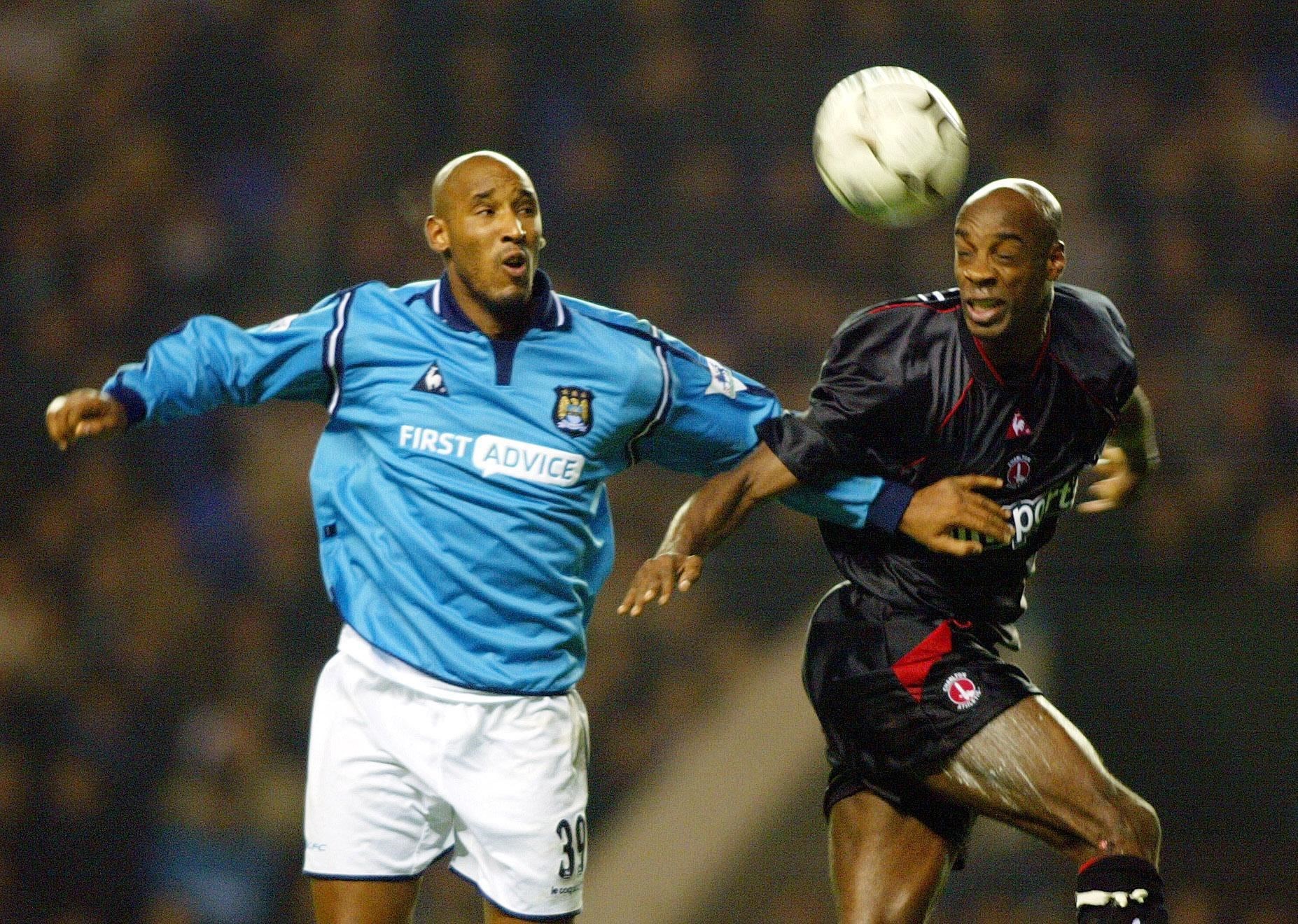 Rufus, right, beats Manchester City’s Nicolas Anelka to a header (PA)