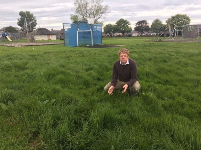 Councillor Tim Eagle examines the state of the uncut grass at buckie Ian johnston Park. Picture: Moray Conservatives