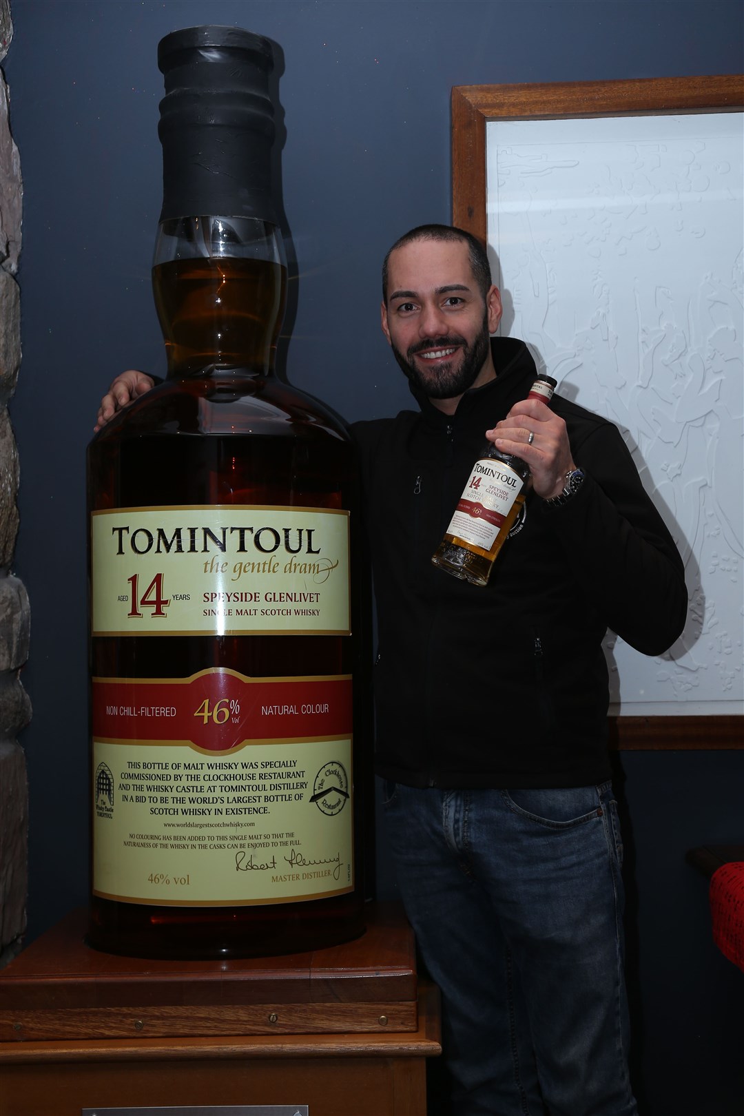 Yuri Bronzina, managing director of Just Whisky, with the huge bottle of Tomintoul 14-year-old.