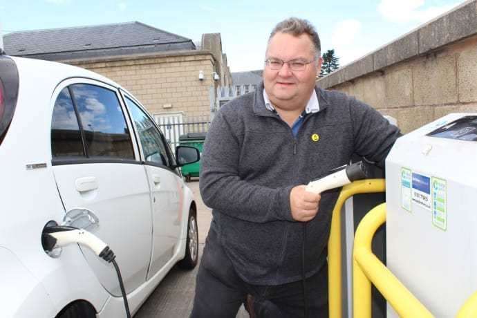 Council leader Graham Leadbitter at the charging point beside the council annexe building in Elgin