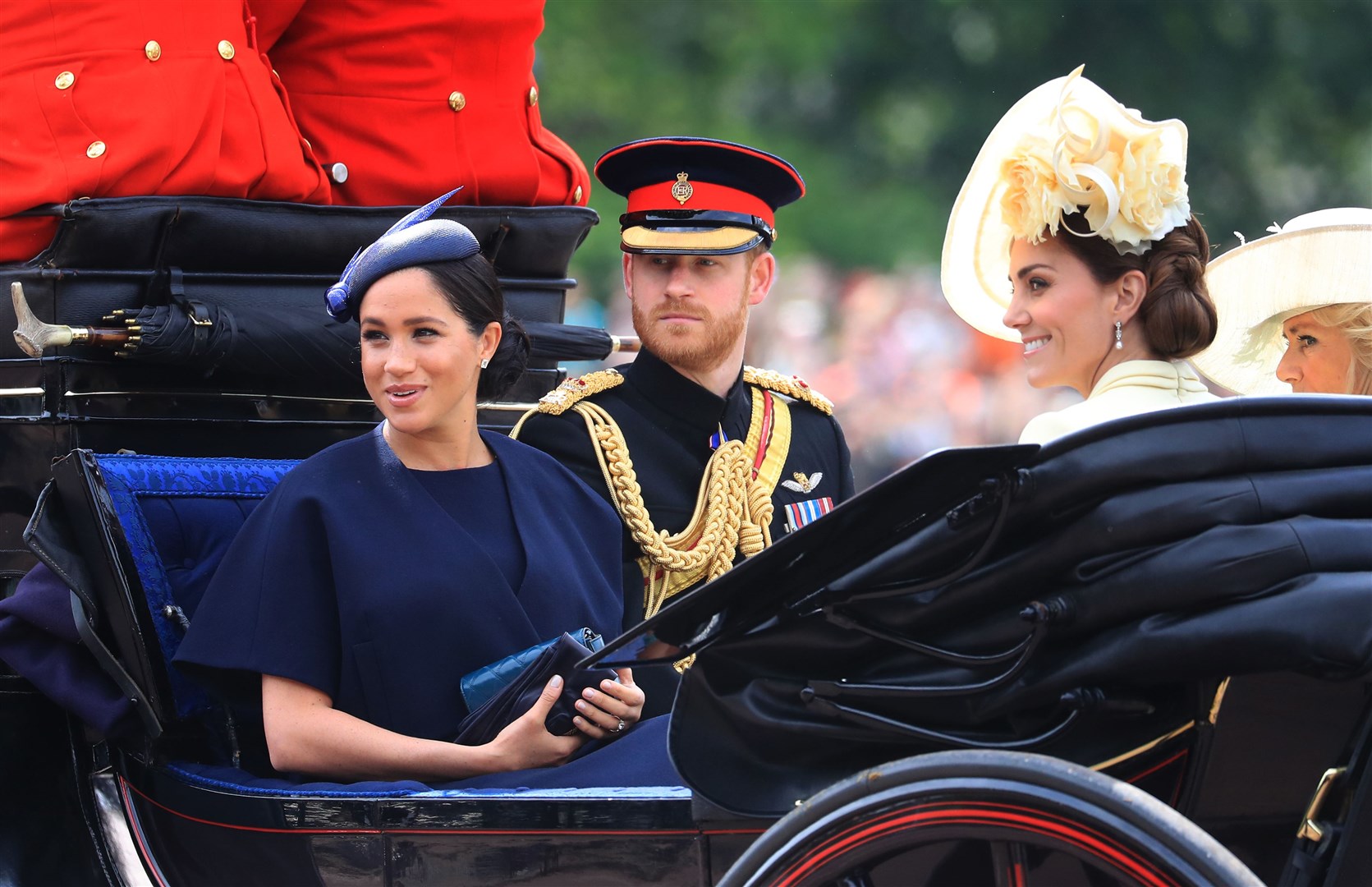 The Duke and Duchess of Sussex with the Duchess of Cambridge make their way along The Mall to Horse Guards Parade ahead of the Trooping the Colour ceremony in 2019 (PA)