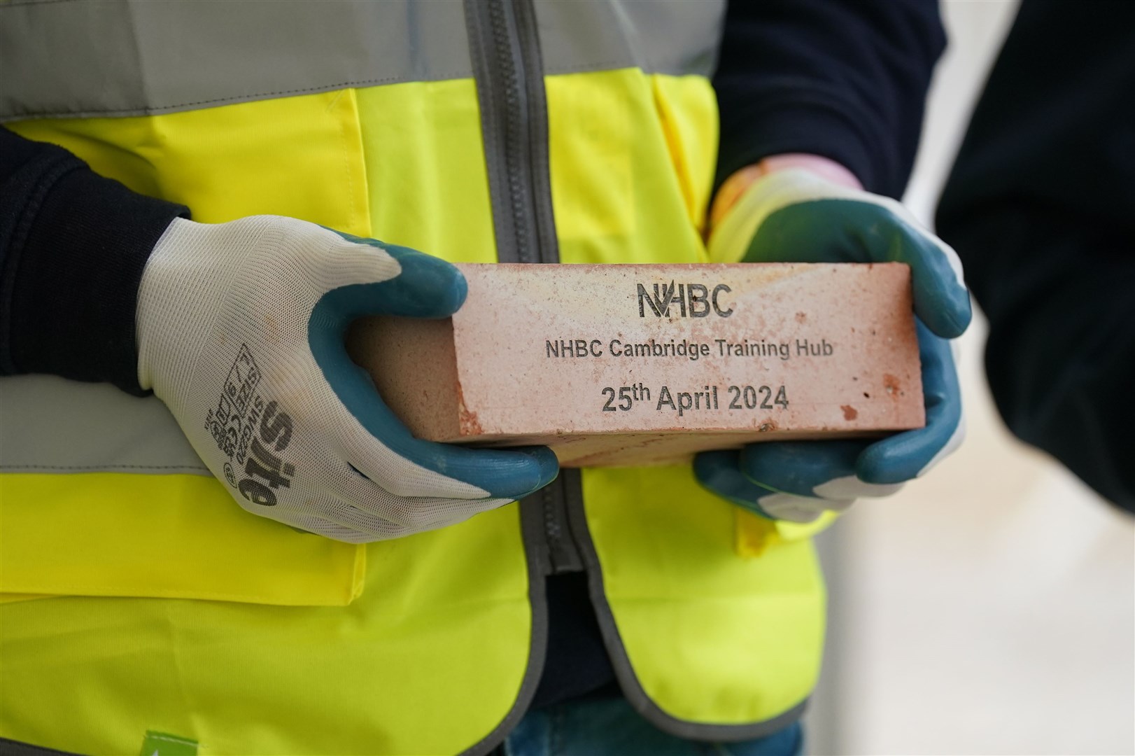 Anne was presented with a commemorative brick after she officially opened the bricklaying training hub (Joe Giddens/ PA)