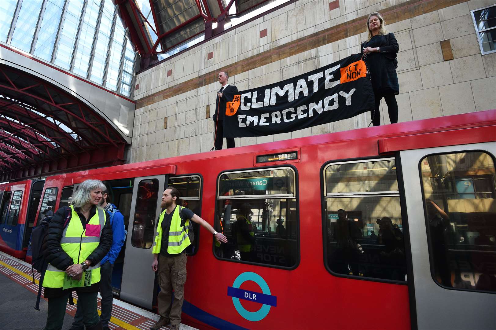 Climate activists protest on a Docklands Light Railway train in London (PA)