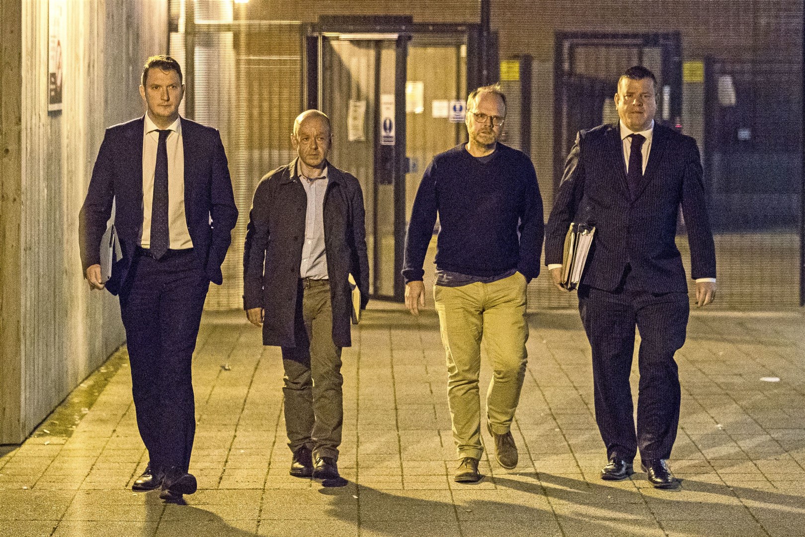 Barry McCaffrey and Trevor Birney and their solicitors John Finucane and Niall Murphy leave Musgrave Street police station in Belfast (Liam McBurney/PA).