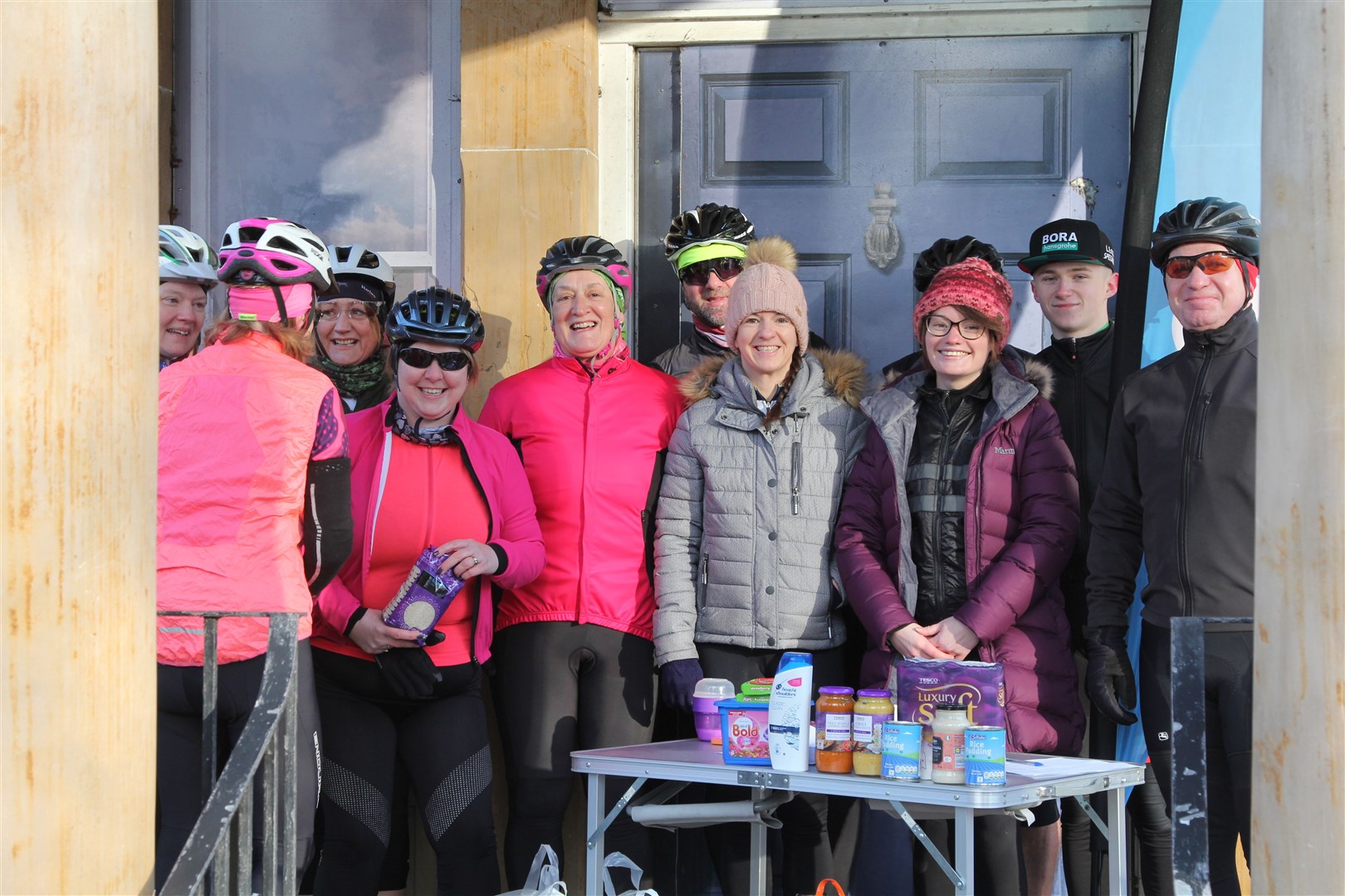 Committee members and riders with their donations at the start line.