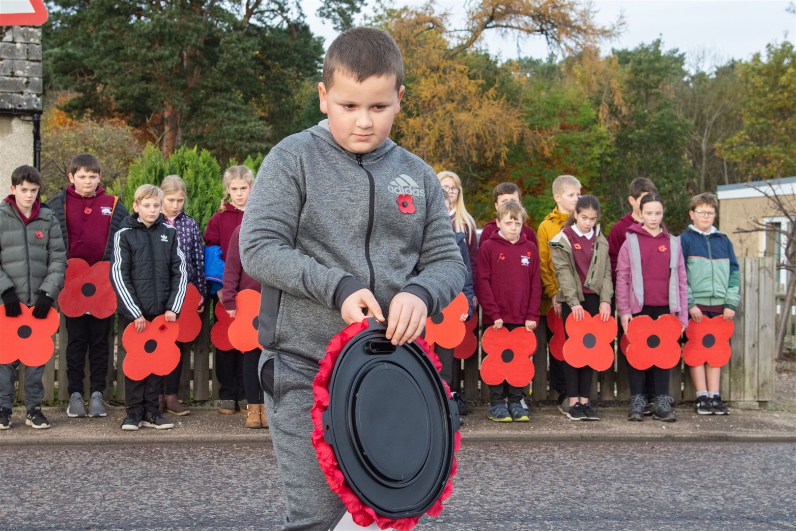 Innes Hendry lays a wreath on behalf of the children and the school community at Mosstowie Primary. Picture: Daniel Forsyth
