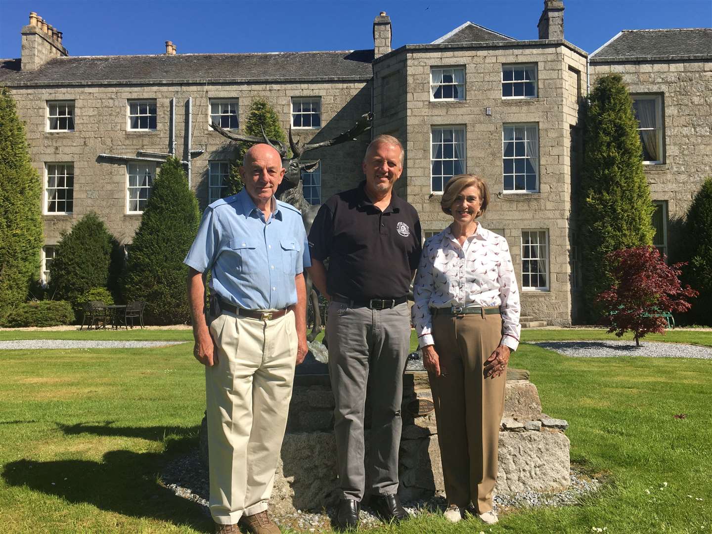 Retiring proprietors, Andrew and Linda Meiklejohn stand either side of Euan Shand of the DTSW Properties, the company which has bought the Castle Hotel at Huntly.