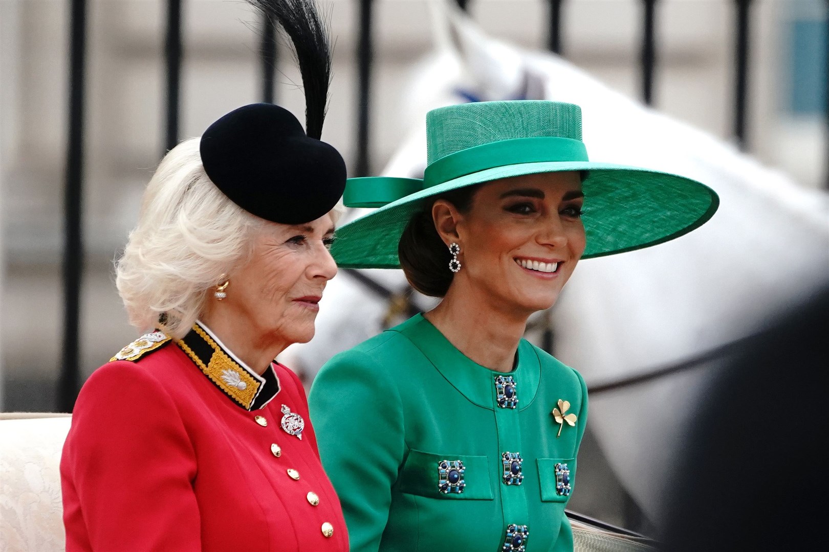 Queen Camilla and the Princess of Wales wore red and green in honour of their regiments (Victoria Jones/PA)