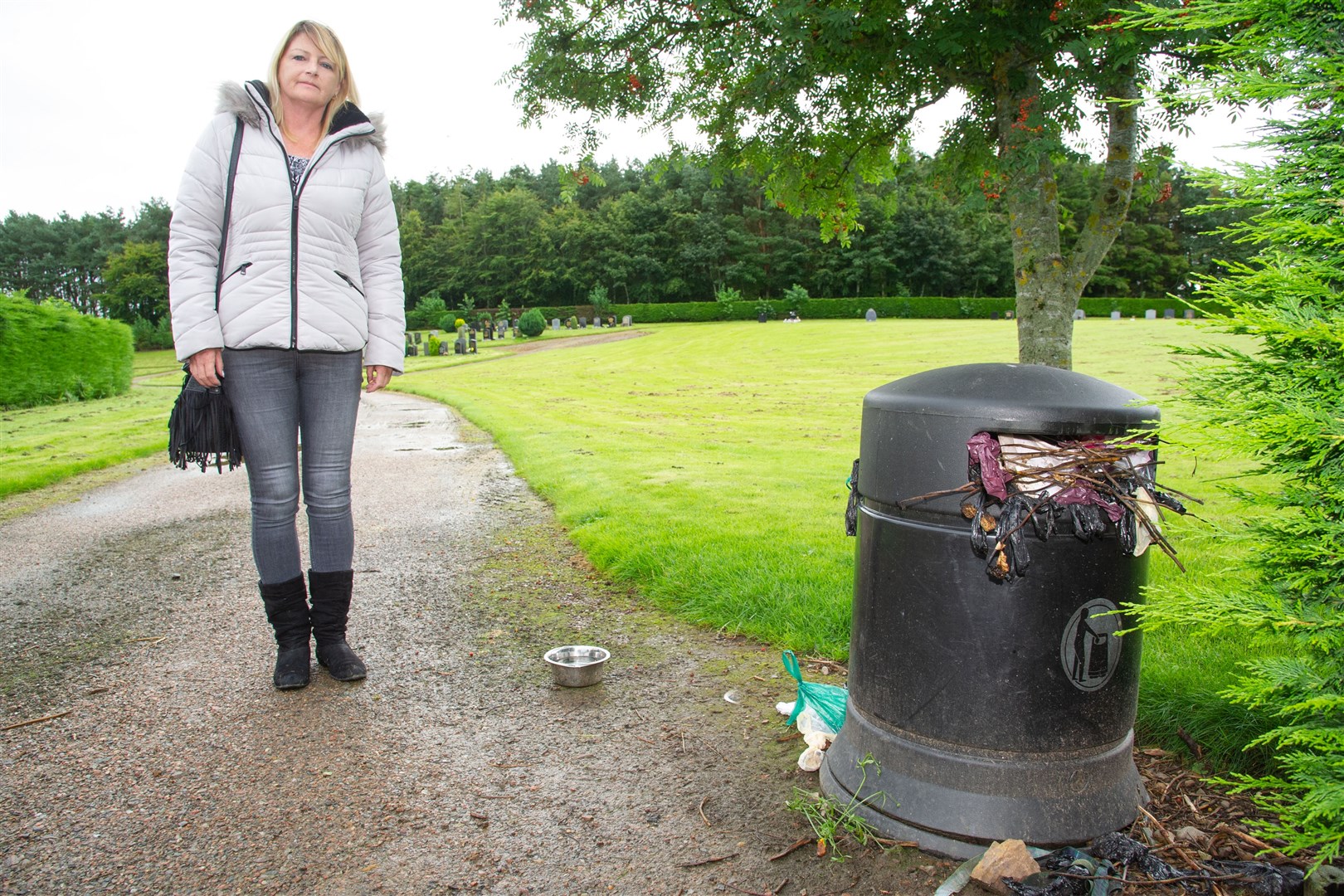 Julie Simpson - whose father’s grave is at Lhanbryde Cemetary - is unhappy with the state of the cemetary, including the overflowing bin that is full of dog waste and is rarely emptied...Picture: Daniel Forsyth. Image No.044620.