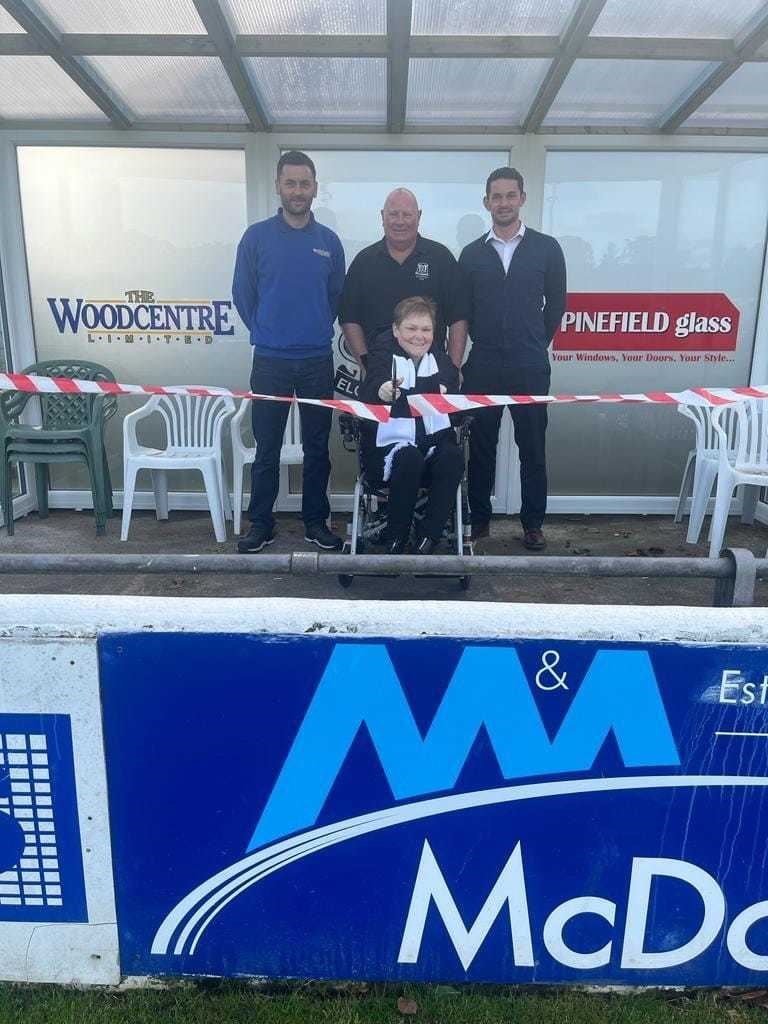 Steven Sim (The Woodcentre Ltd, left) and Martin Charlesworth (Pinefield Glass) help Elgin City Supporters Club committee members Bert Grant and Louise Ferguson to officially open the new accessibility centre at Borough Briggs.