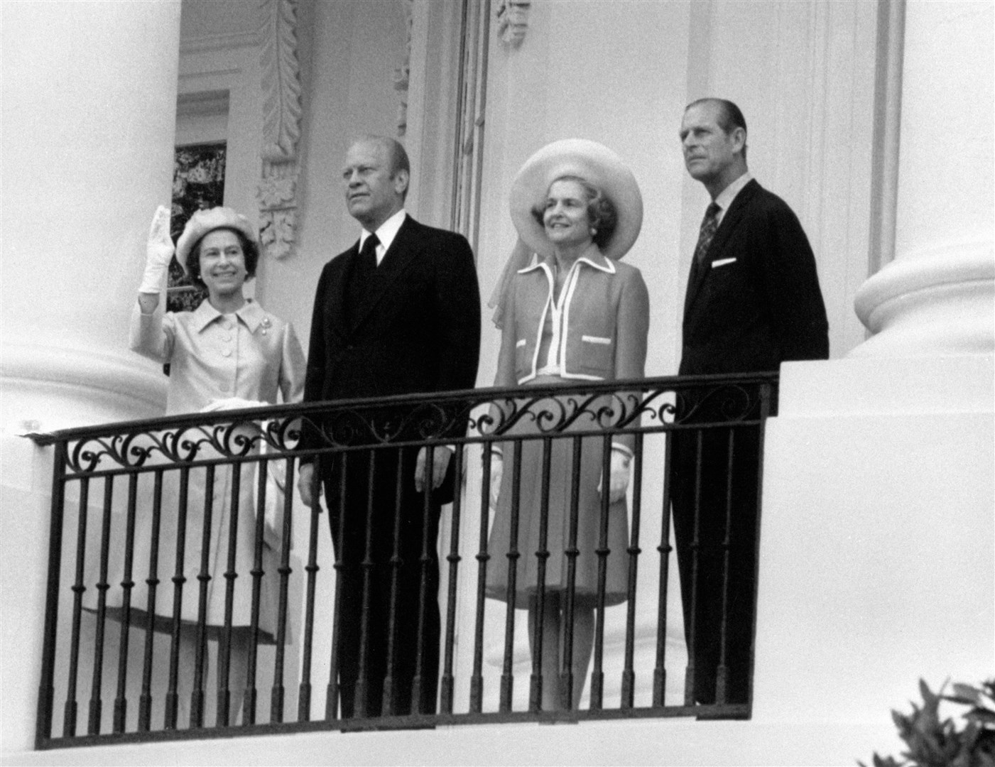 The Queen waves from the balcony of the White House in Washington as she stands with President Gerald Ford, his wife, first lady Betty Ford, and the Duke of Edinburgh (Archive/PA)