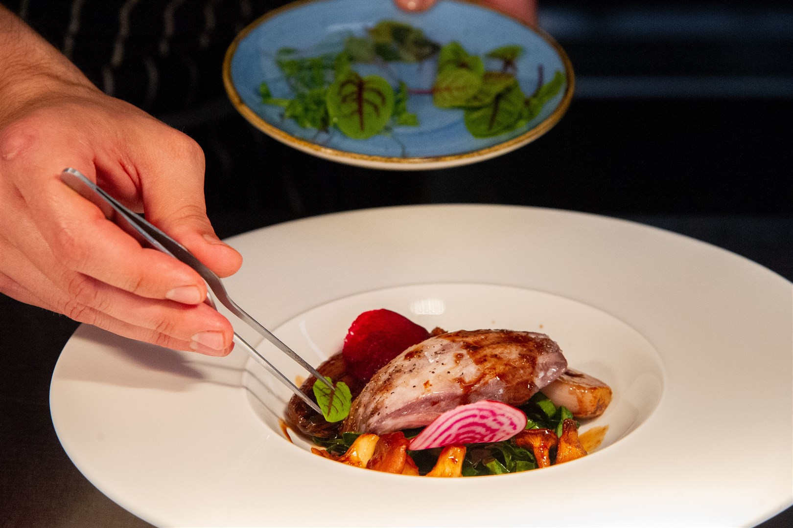 Applying the final touches to a locally produced dish. Picture: Daniel Forsyth.