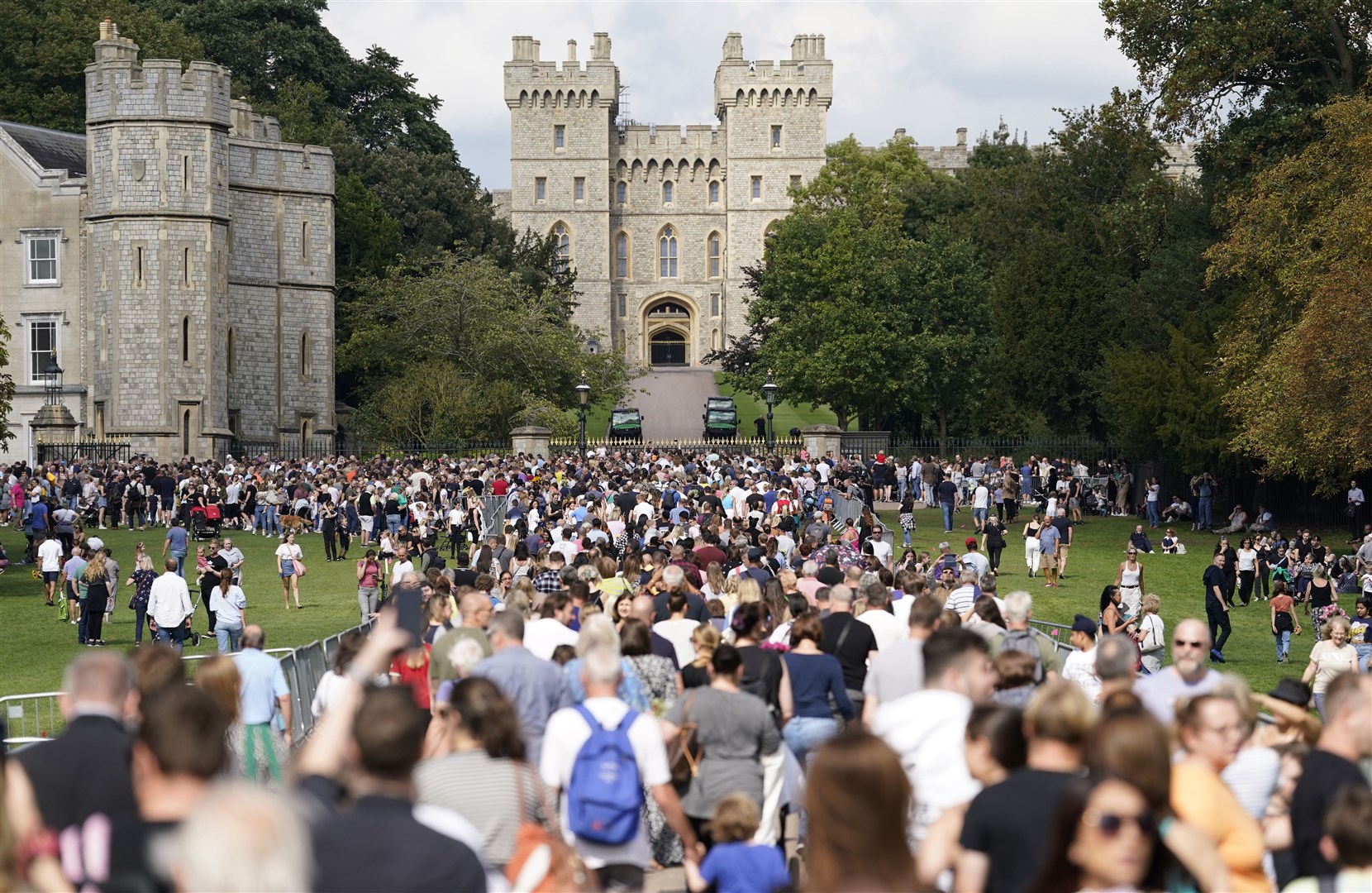 People make their way along the Long Walk towards Cambridge Gate outside Windsor Castle to lay flowers following the death of the Queen (Andrew Matthews/PA)