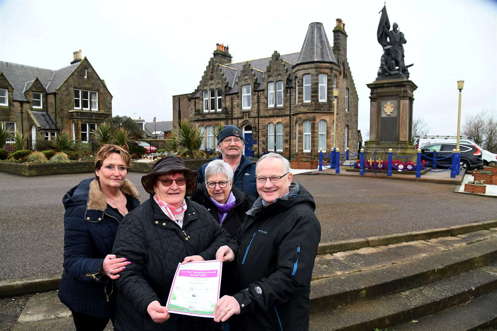 Buckie's Roots chairwoman Meg Jamieson and group member Gifford Leslie proudly show off the It's Your Neighbourhood award, joined by fellow group members (from left) Morag Stewart, Evelyn Flett and Archie Jamieson. Picture: Becky Saunderson