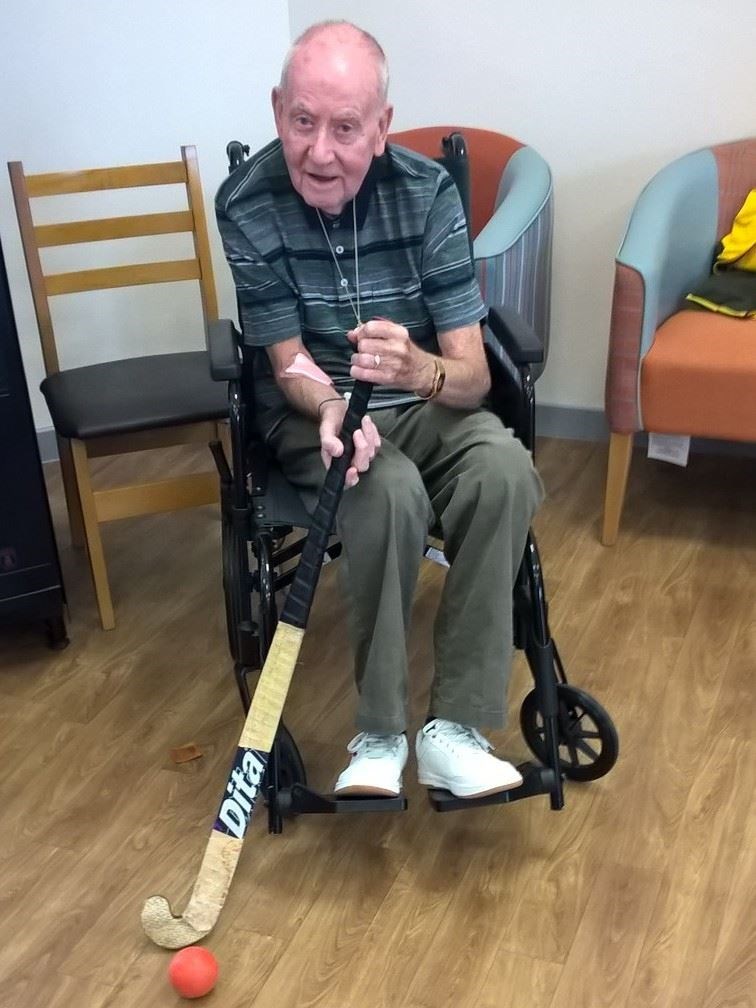 A participant in the Walking Hockey session demonstrates his new skills.