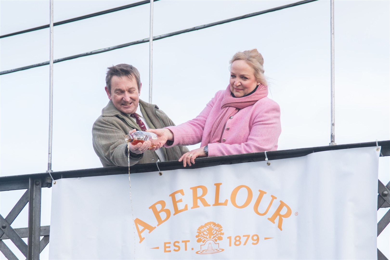 Roger Knight and wife Beryl Bokor-Knight pour a bottle of Aberlour whisky into waters...The opening ceremony for the River Spey, held at the Penny Bridge in Alice Littler Park, Aberlour. ..Picture: Daniel Forsyth..