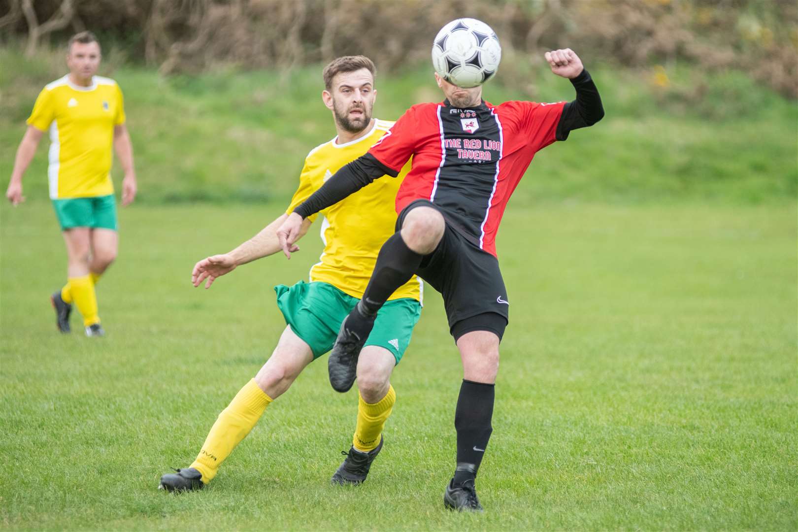 Hopeman's Connor McArthur and Fochabers' Gary Burchell compete for the ball...Hopeman FV vs Fochabers FC - Moray Welfare League...Picture: Daniel Forsyth..