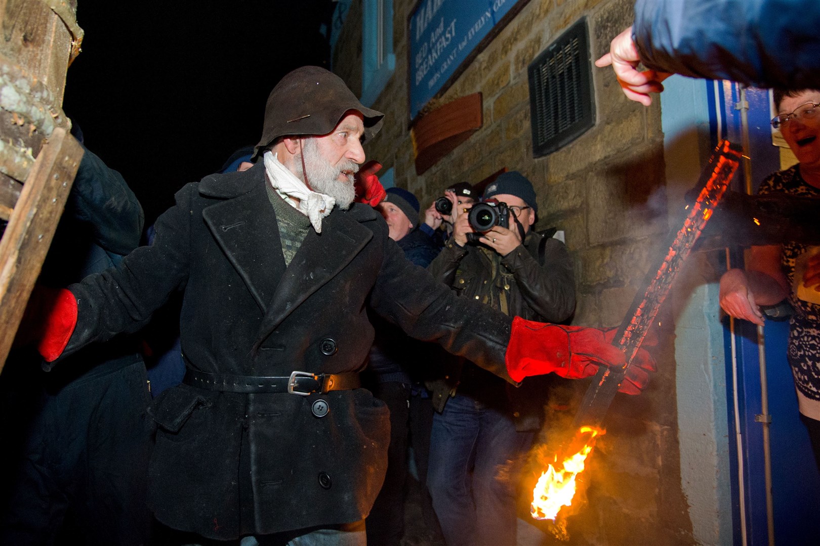 The village of Burghead welcome in the 2019 New Year on the 11th of January with their traditional Burning of the Clavie Celebration...Clavie King Dan Ralph hands out a burning stave to the Harbour Inn as a gift of good luck for the year ahead...Picture: Daniel Forsyth. Image No.042962.