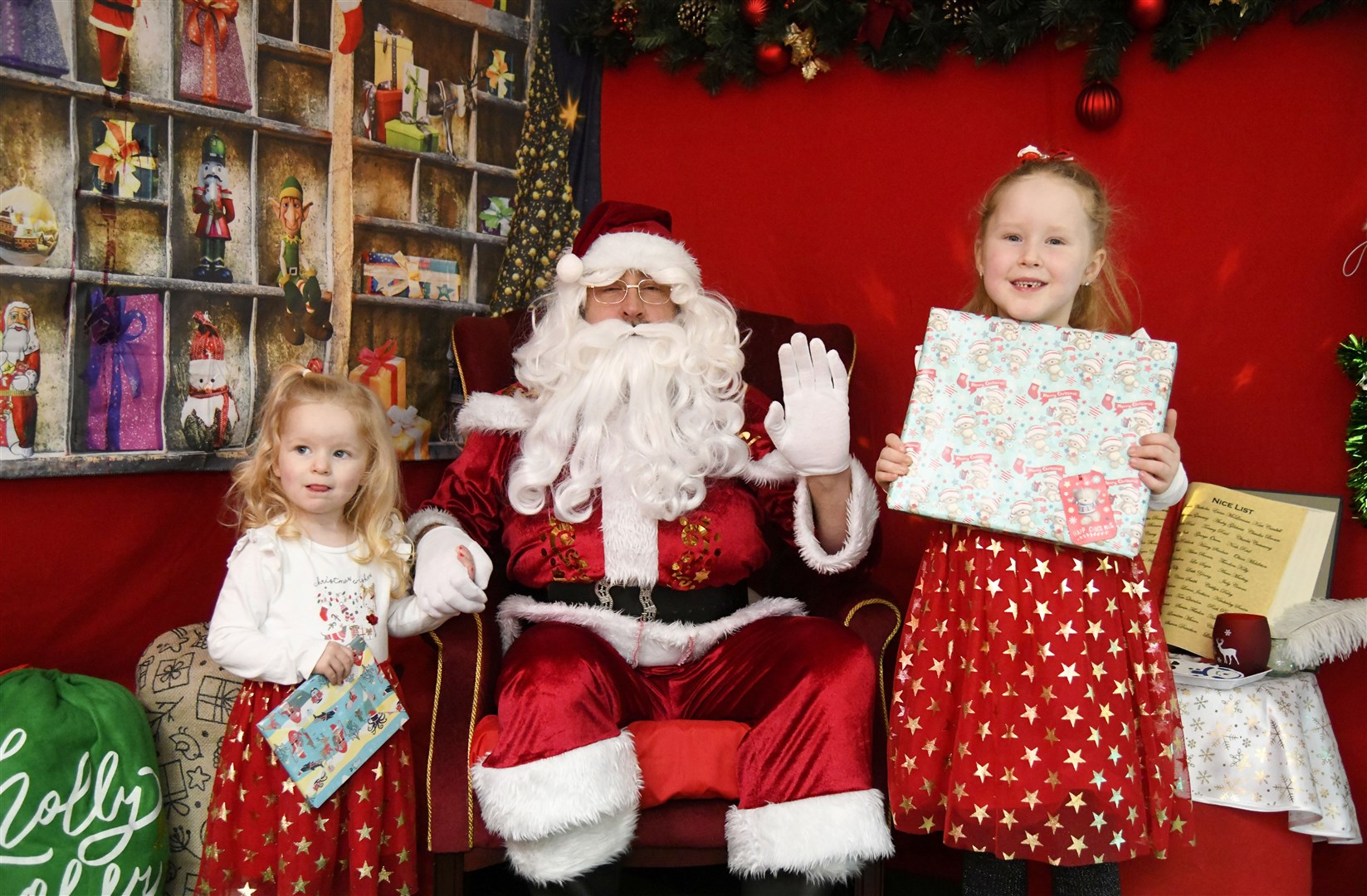 Santa with Merida (left) Amelia-May Forrest (right) at his Grotto in the St Giles Centre in Elgin...Pictre: Beth Taylor.