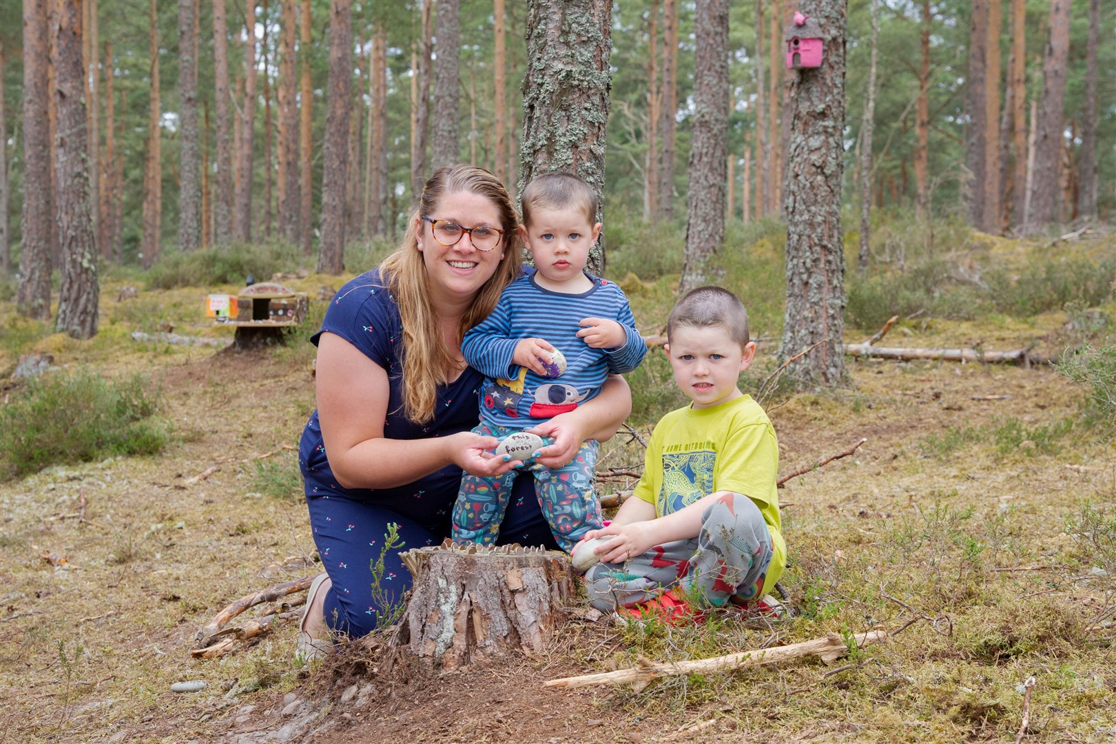 Ericka, Zac and Clark Murchison. A small village has been made out of wooden houses and household items in the Lossie Forest woodland. Picture: Daniel Forsyth.