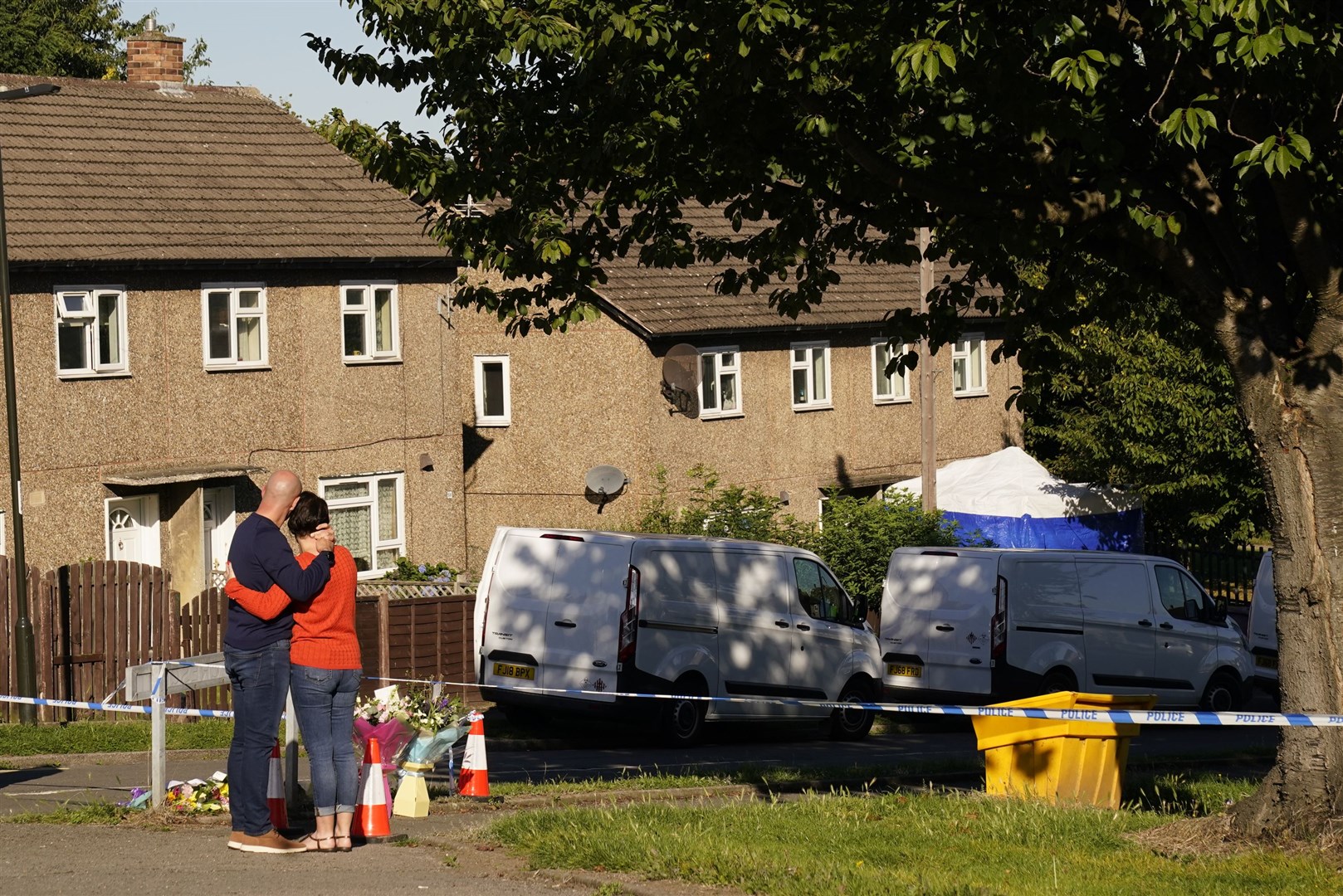 Jason Bennett leaves flowers at the scene in Chandos Crescent, Killamarsh, near Sheffield, where his two children were found dead at a house on Sunday (Danny Lawson/PA)