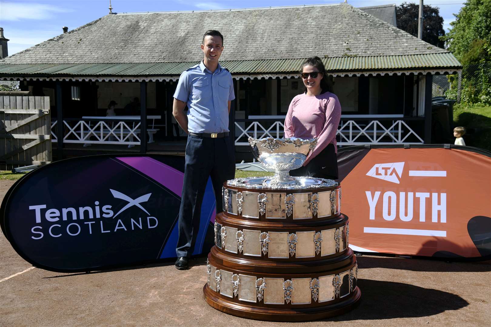 Tom Elwick (left) and Jasmin Taylor (right) with the Davis Cup trophy at Elgin Lawn Tennis Club as part of a nationwide tour...Davis Cup in Elgin...Picture: Beth Taylor.